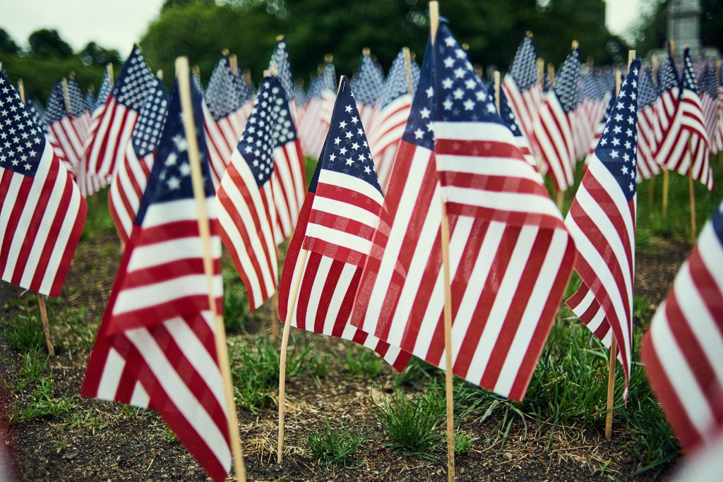 Flags in a yard representing fallen soldiers.